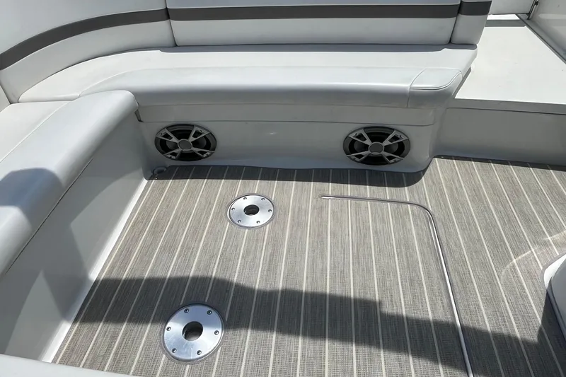 Slide: The Image of 2002 Formula 330 Sun Sport boat interior with cushioned seating and speakers. - 6