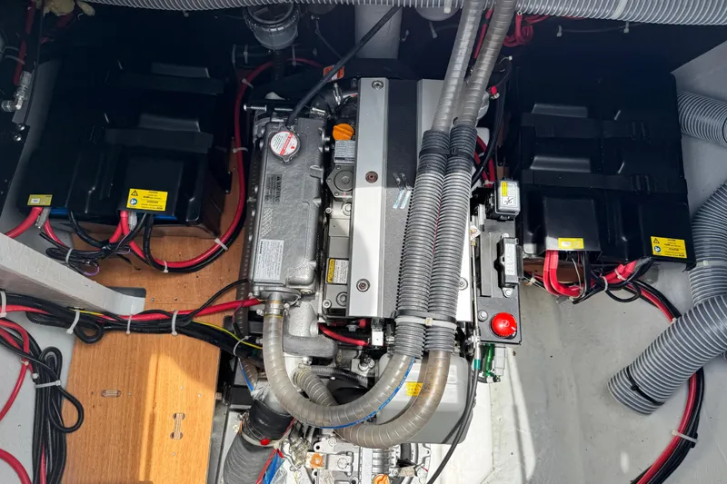 Slide: The Image of Engine compartment of a 2025 Lagoon 46 yacht, showcasing wiring and components. - 11