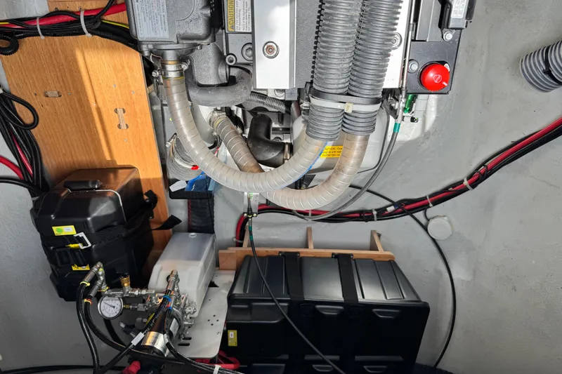 Slide: The Image of Engine compartment of a 2025 Lagoon 46 yacht, showcasing mechanical components and wiring. - 12