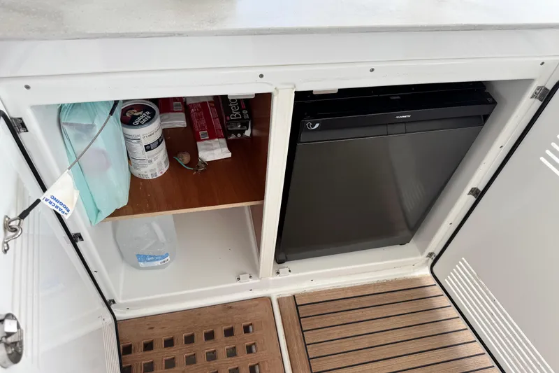 Slide: The Image of Cabinet storage on Lagoon 46 yacht, featuring shelves and a compact refrigerator. - 19