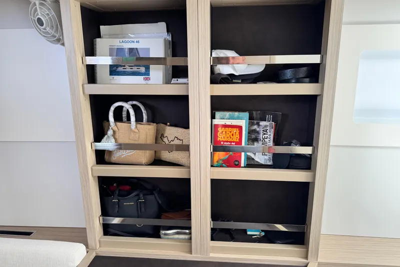 Slide: The Image of Cabin shelf on Lagoon 46 yacht with books, bags, and manuals. - 22