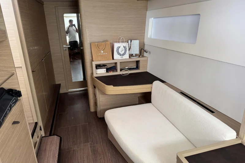 Slide: The Image of Interior of 2025 Lagoon 46 yacht with modern furnishings and wooden accents. - 23