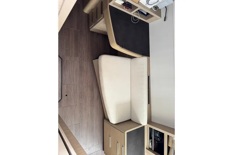Slide: The Image of Interior of 2025 Lagoon 46 yacht with modern wood flooring and seating. - 24