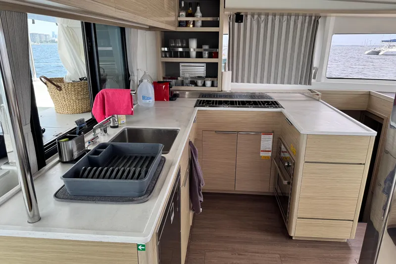 Slide: The Image of Modern kitchen interior on 2025 Lagoon 46 yacht with ocean view. - 29