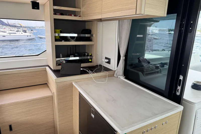 Slide: The Image of Modern interior of 2025 Lagoon 46 yacht with sleek cabinetry and ocean view. - 31