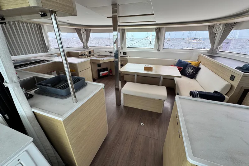 Slide: The Image of Interior of 2025 Lagoon 46 catamaran with modern kitchen and seating area. - 33