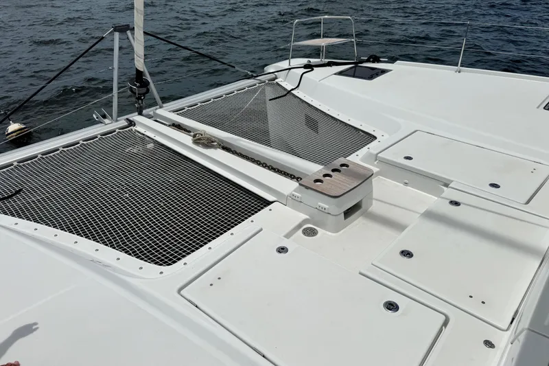 Slide: The Image of Deck view of 2025 Lagoon 46 catamaran with netting and storage compartments. - 38