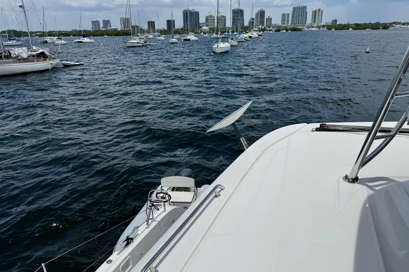 Slide: The Image of Lagoon 46 catamaran on water, city skyline in background, 2025 model. - 39