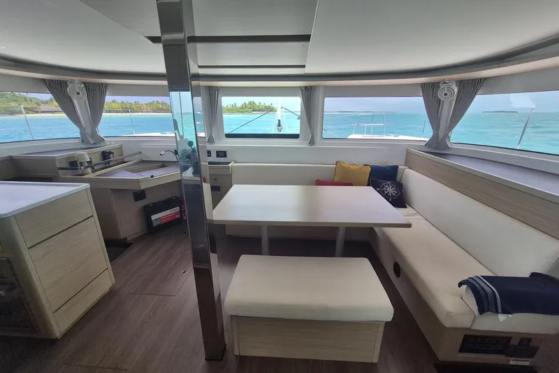 Slide: The Image of Interior of 2025 Lagoon 46 catamaran with modern seating and ocean view. - 4
