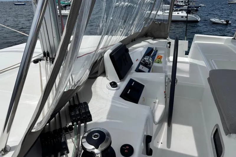 Slide: The Image of Cockpit of 2025 Lagoon 46 catamaran with steering wheel and control panel. - 41