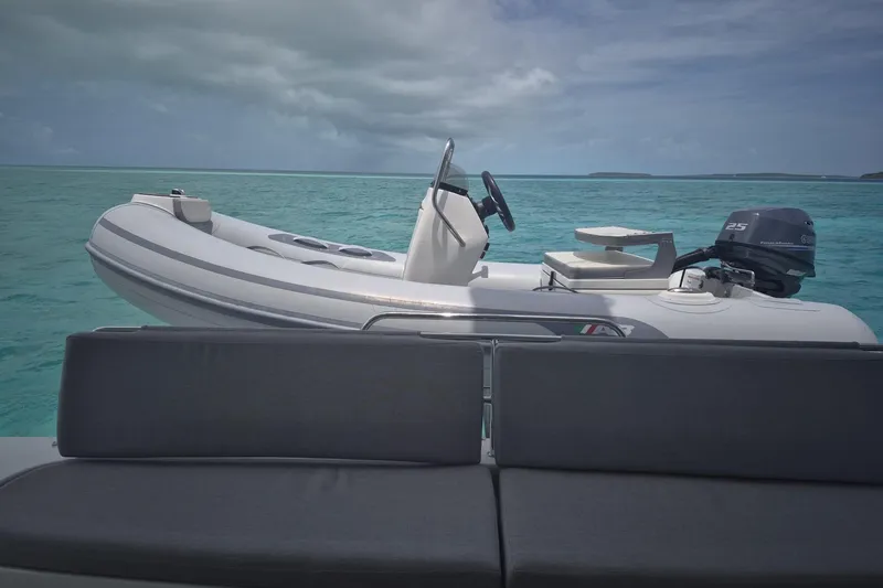Slide: The Image of Inflatable boat on Lagoon 46 yacht, 2025 model, in turquoise ocean waters. - 6
