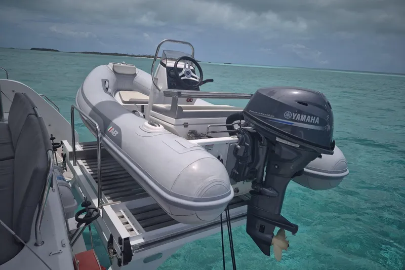 Slide: The Image of Inflatable boat with Yamaha motor on Lagoon 46 yacht, 2025 model, in turquoise waters. - 8