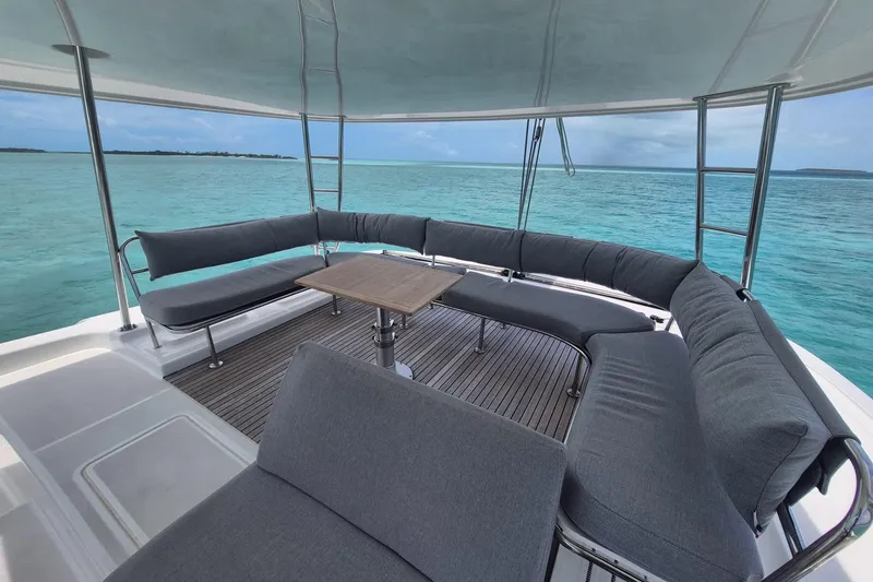 Slide: The Image of Spacious deck of 2025 Lagoon 46 yacht with ocean view and comfortable seating. - 9