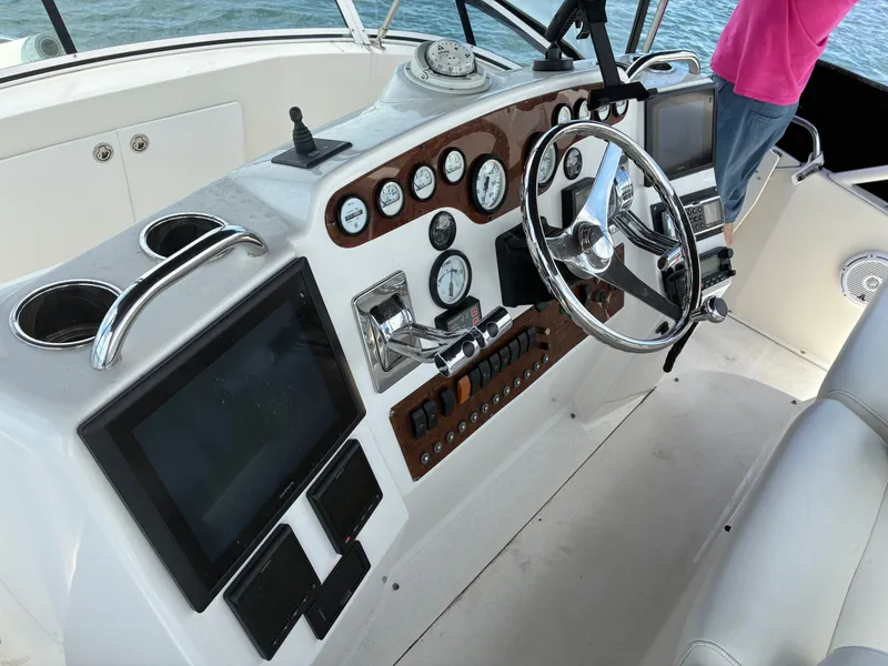 Slide: The Image of The image shows the helm of a 2001 Silverton 392 Motor Yacht with various instruments. - 10