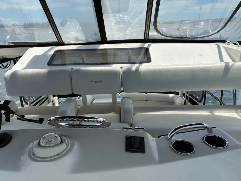 Slide: The Image of The cockpit of a 2001 Silverton 392 Motor Yacht with steering and instruments. - 11