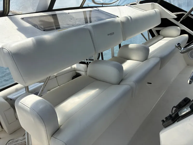 Slide: The Image of The image shows the cockpit of a 2001 Silverton 392 Motor Yacht with white leather seating. - 12