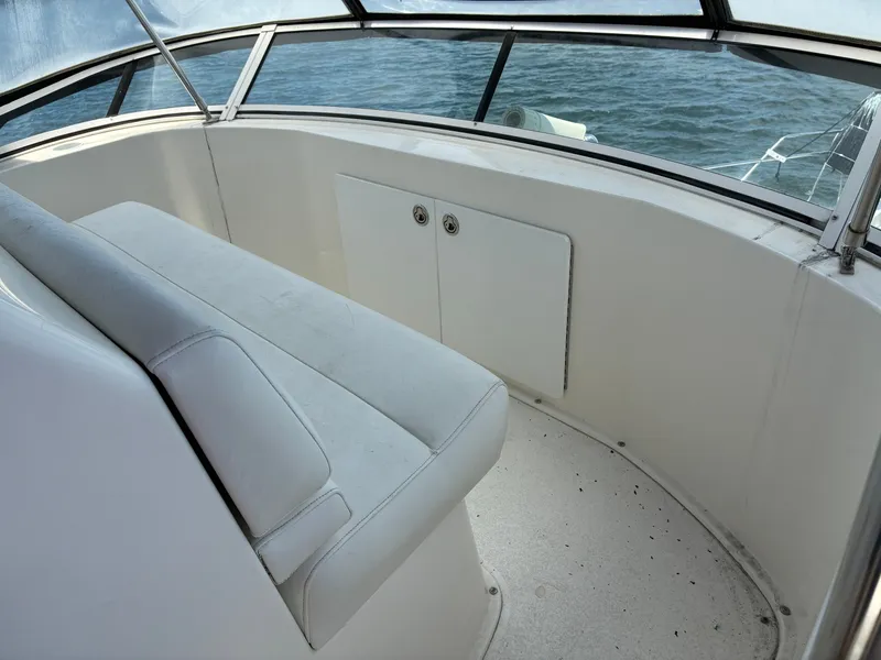 Slide: The Image of The image shows the seating area of a 2001 Silverton 392 Motor Yacht with a view of the water. - 13