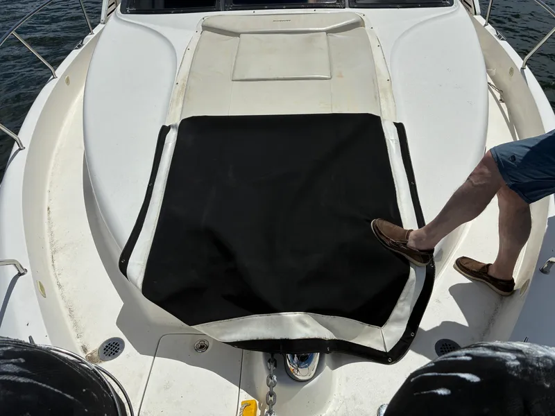 Slide: The Image of A man stands on the deck of a 2001 Silverton 392 Motor Yacht. - 17