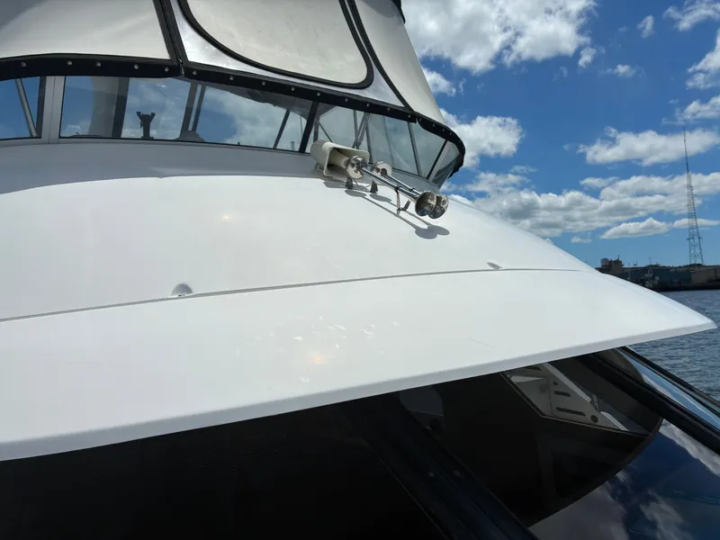 Slide: The Image of The 2001 Silverton 392 Motor Yacht features a sleek white deck with clean lines. - 18