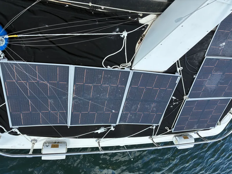Slide: The Image of Solar panels on a boat, mounted on the deck, with water in the background. - 19