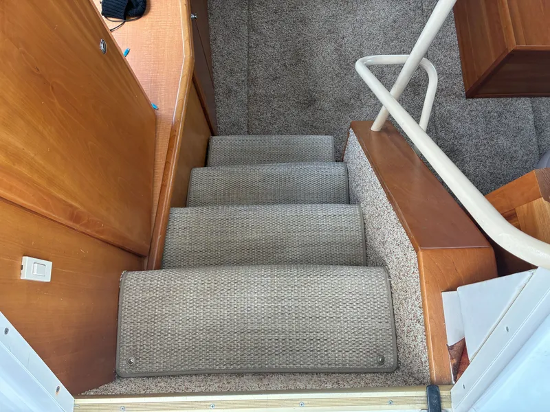 Slide: The Image of Carpeted steps lead into the interior of the 2001 Silverton 392 Motor Yacht. - 21
