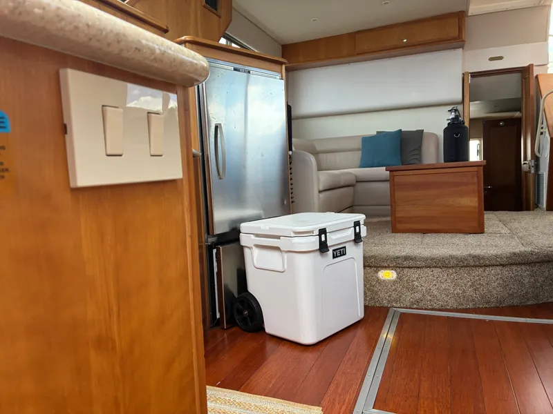 Slide: The Image of Interior of a 2001 Silverton 392 Motor Yacht with wooden flooring and a cozy seating area. - 24