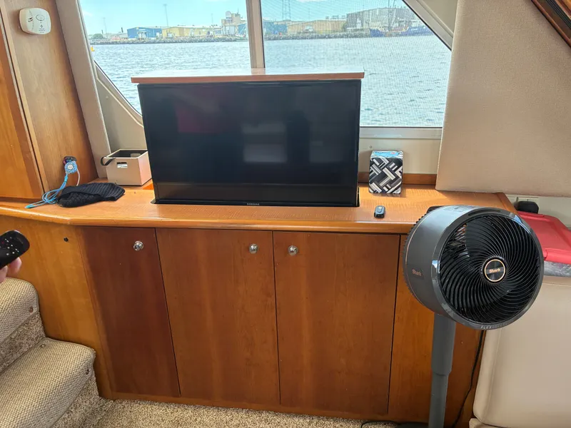 Slide: The Image of Interior of a 2001 Silverton 392 Motor Yacht with a TV and fan. - 28