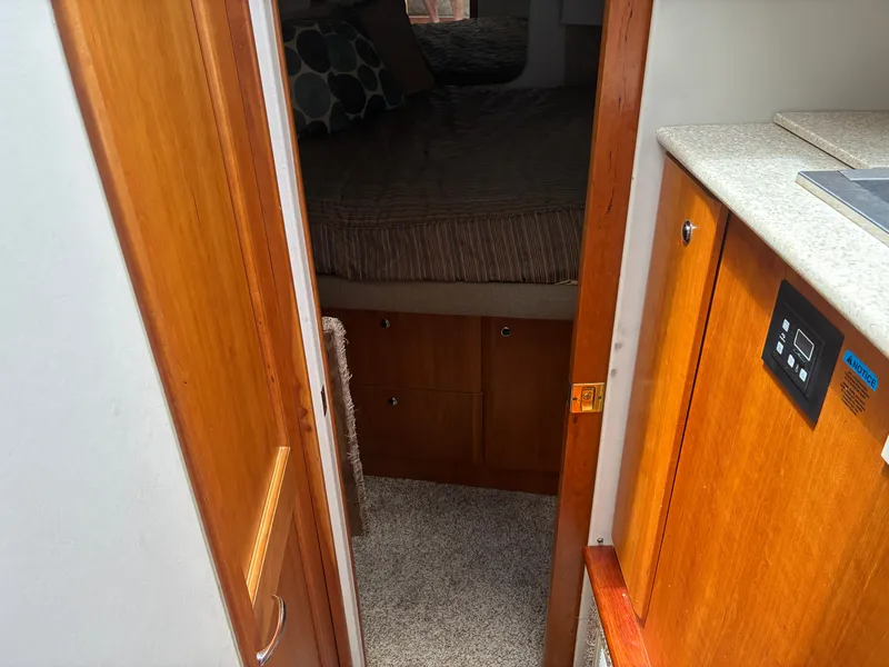 Slide: The Image of Interior of a 2001 Silverton 392 Motor Yacht with wood furnishings and carpeted floor. - 29