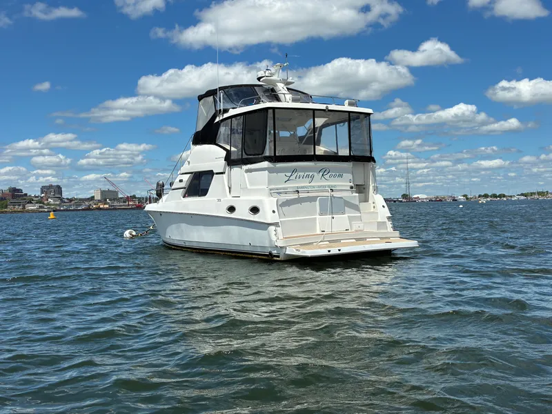 Slide: The Image of 2001 Silverton 392 Motor Yacht on calm water under a blue sky with white clouds. - 3