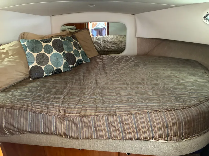 Slide: The Image of Interior of the 2001 Silverton 392 Motor Yacht featuring a cozy bed with pillows. - 30