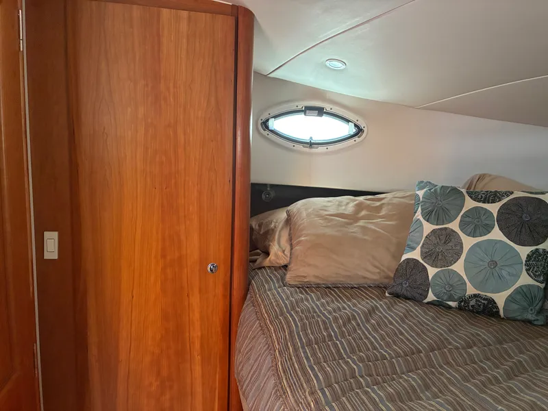 Slide: The Image of Interior of the 2001 Silverton 392 Motor Yacht with a cozy bed and wooden furnishings. - 32