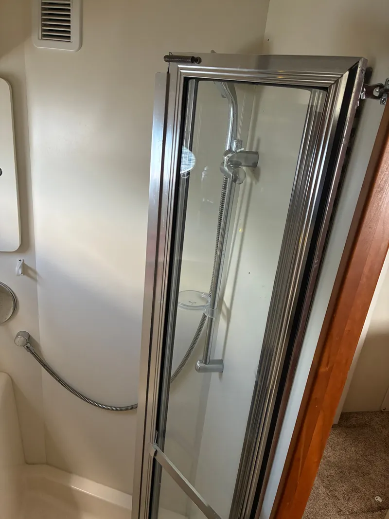 Slide: The Image of Shower cabin in a yacht with glass door and chrome fixtures. - 38