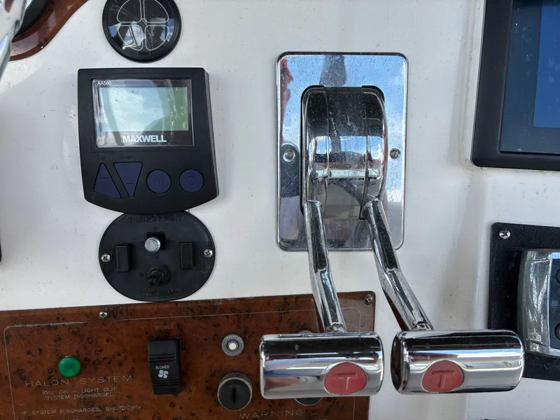 Slide: The Image of Close-up of the control console on a 2001 Silverton 392 Motor Yacht with levers and instruments. - 41