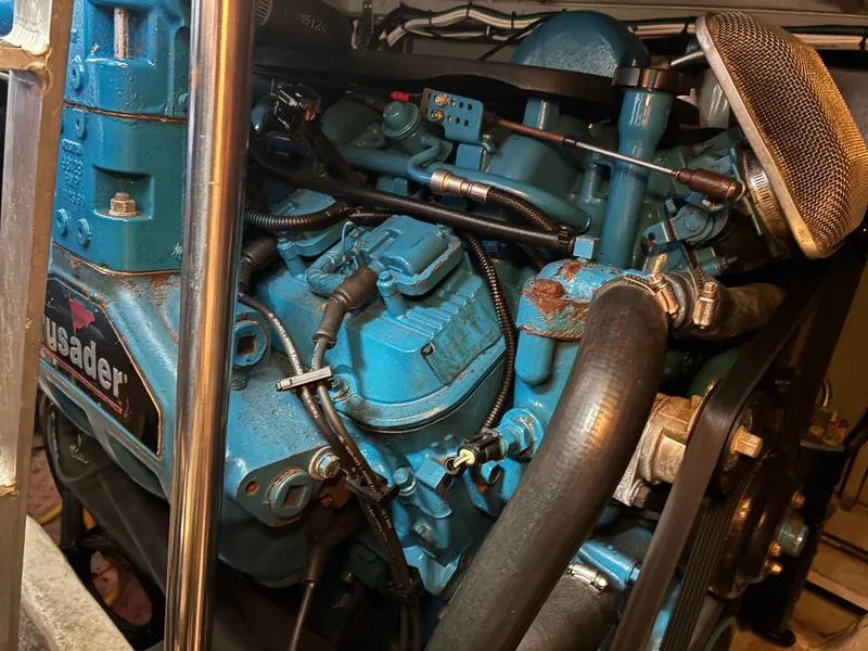Slide: The Image of A blue-painted engine in an engine room, surrounded by pipes and cables. - 44