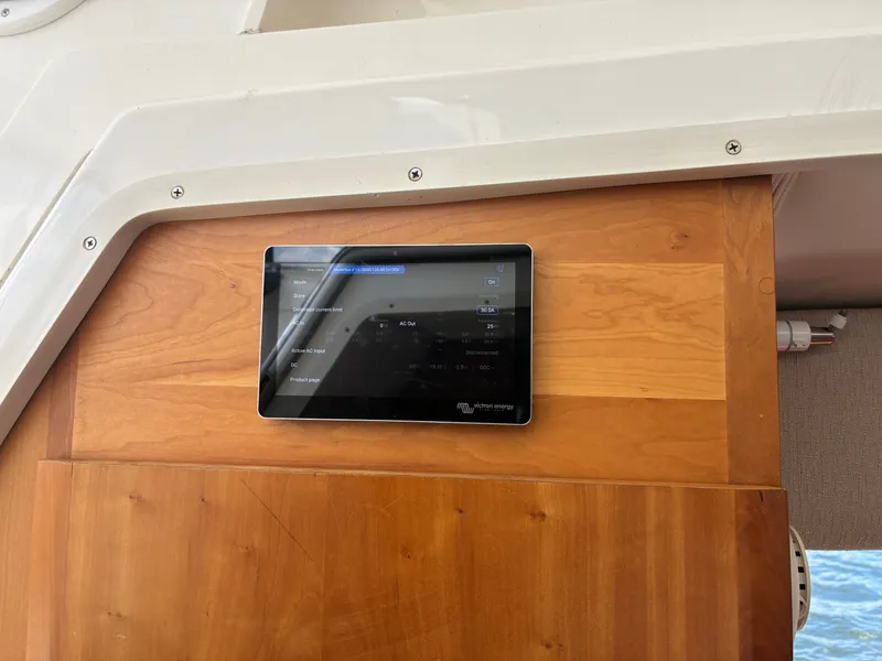 Slide: The Image of A modern control tablet is mounted on a wooden wall inside a yacht. - 47