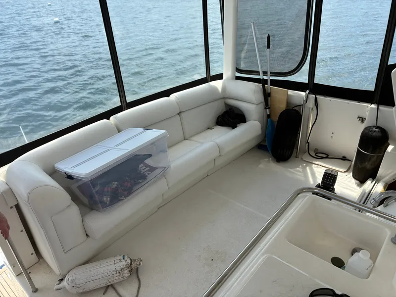 Slide: The Image of Interior of a 2001 Silverton 392 Motor Yacht with white sofa and view of the water. - 5