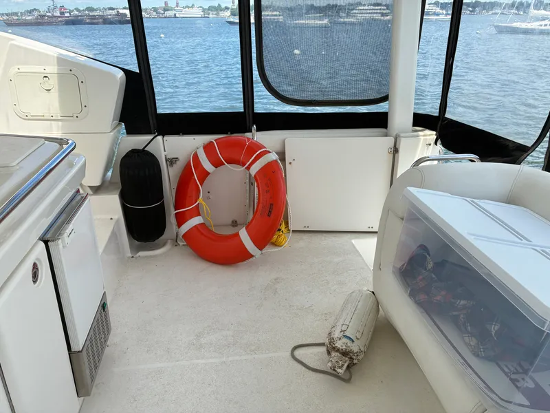 Slide: The Image of The image shows the deck of a 2001 Silverton 392 Motor Yacht. A life ring is visible. - 7