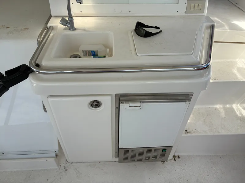 Slide: The Image of A small kitchenette with a sink and fridge on a yacht. - 8