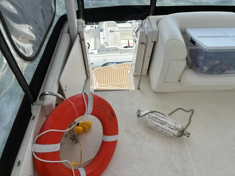 Slide: The Image of The image shows the deck of a 2001 Silverton 392 Motor Yacht with a lifebuoy and fender. - 9