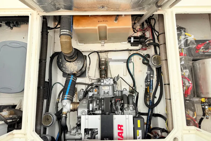 Slide: The Image of Engine compartment of a 2009 Ranger Tugs R-29 boat, showcasing mechanical components. - 20