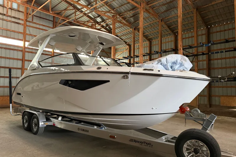 Slide: The Image of 2026 Yamaha Boats 295SD in a warehouse on a trailer. - 1