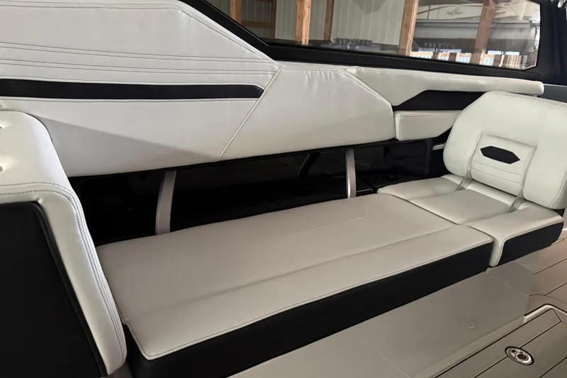 Slide: The Image of 2026 Yamaha Boats 295SD interior with sleek, modern seating design in white and black. - 10