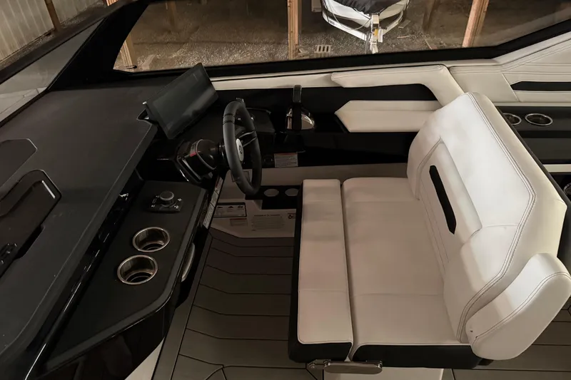 Slide: The Image of Interior of 2026 Yamaha Boats 295SD, featuring sleek helm and modern seating design. - 12