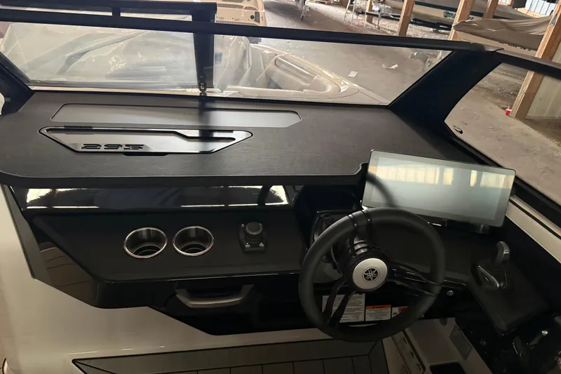 Slide: The Image of 2026 Yamaha Boats 295SD dashboard with steering wheel and digital display in a modern cockpit. - 13