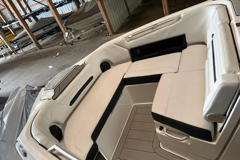 Slide: The Image of 2026 Yamaha Boats 295SD interior with spacious seating in a storage facility. - 14
