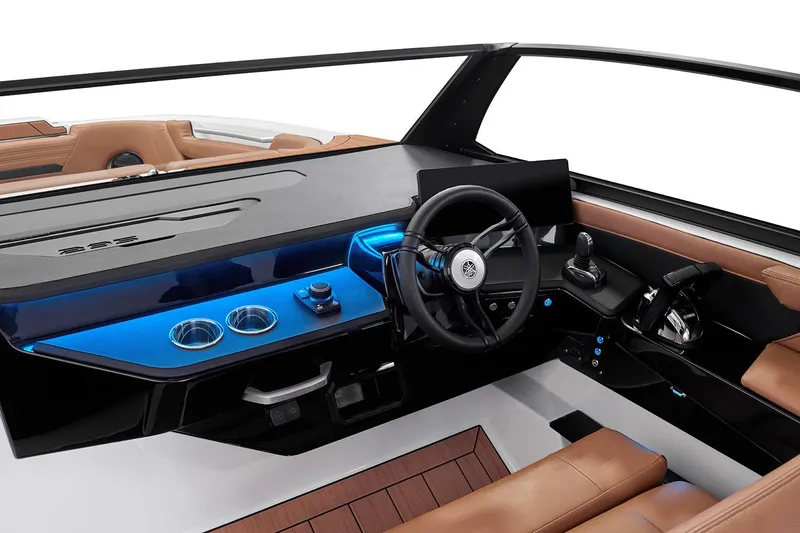 Slide: The Image of Manufacturer Provided Image: 2026 Yamaha Boats 295SD cockpit with modern steering, controls, and blue ambient lighting. - 24
