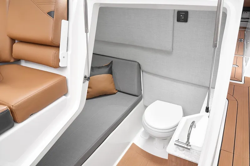 Slide: The Image of Manufacturer Provided Image: 2026 Yamaha Boats 295SD interior cabin with seating, toilet, and sink. - 29