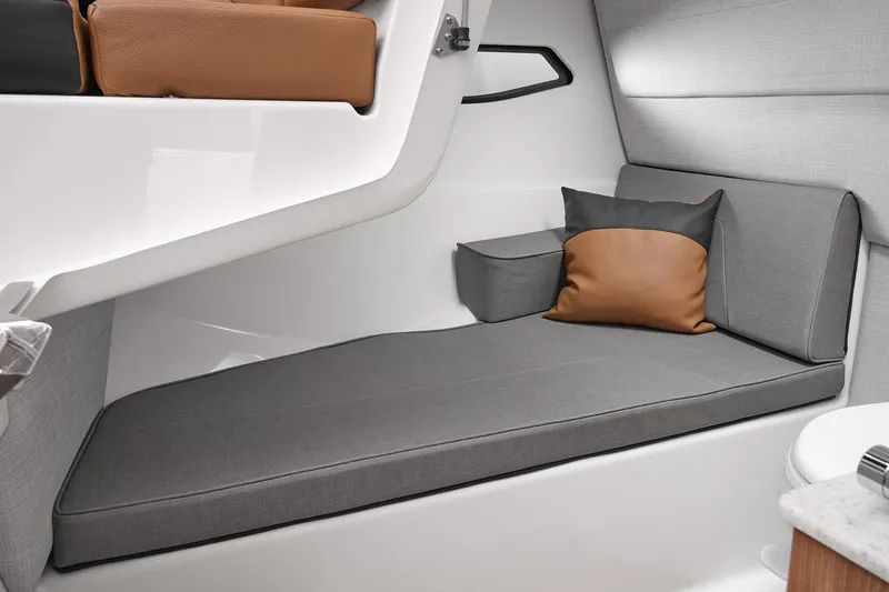 Slide: The Image of Manufacturer Provided Image: 2026 Yamaha Boats 295SD interior cabin with gray seating and decorative pillows. - 30