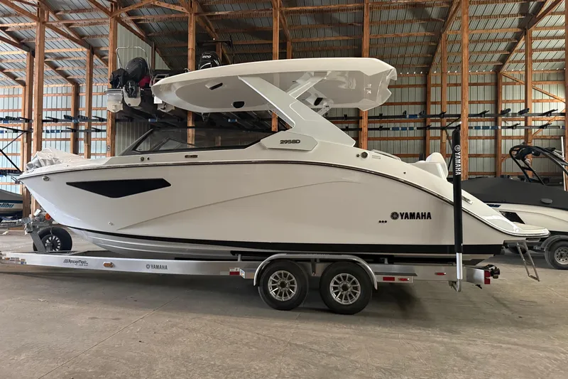 Slide: The Image of 2026 Yamaha Boats 295SD in storage, side view on trailer. - 4
