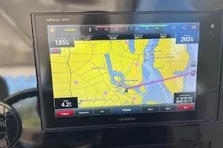 Slide: The Image of Garmin GPS display on 2019 Pursuit OS 325 Offshore boat, showing nautical navigation map. - 13